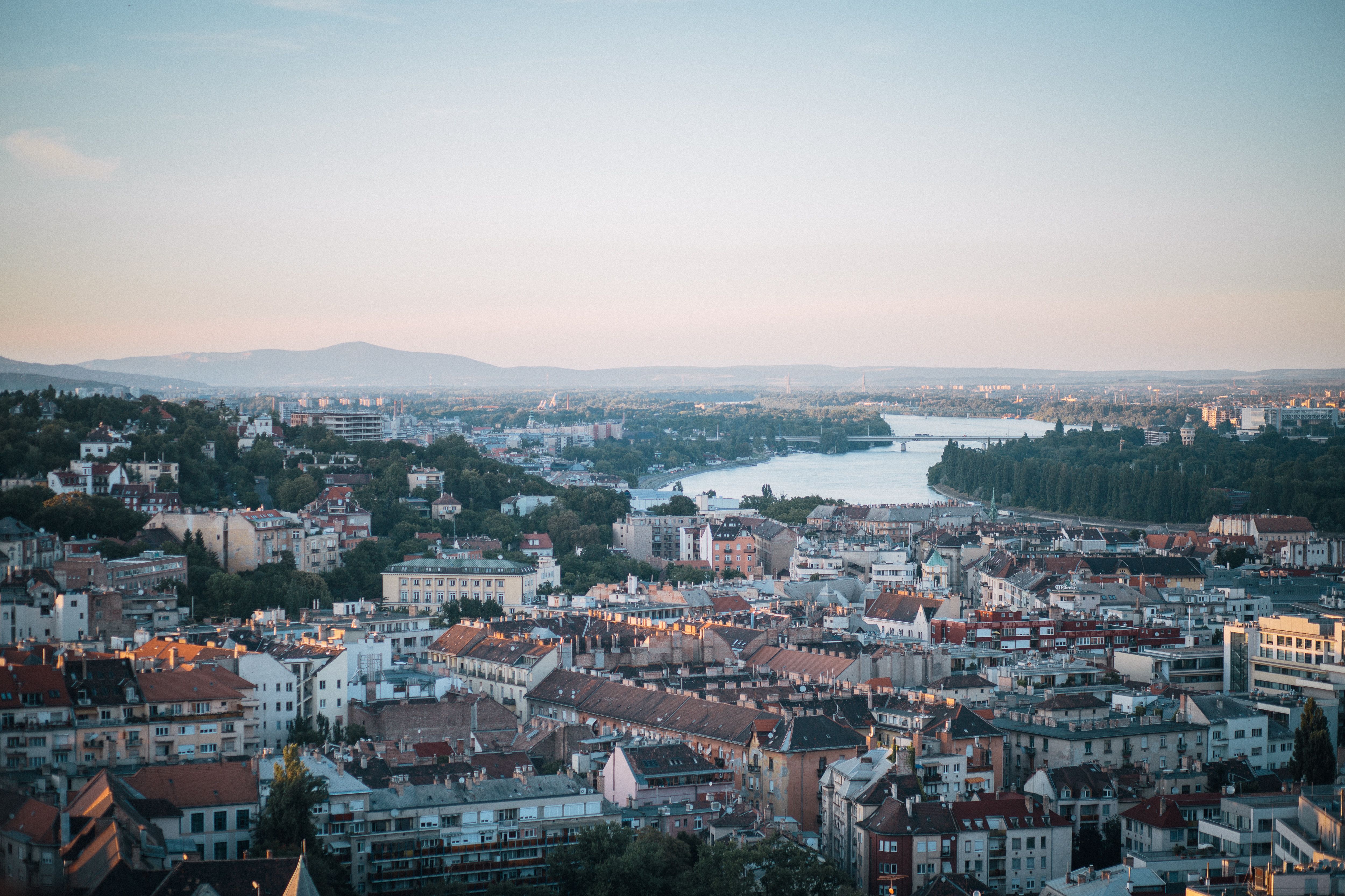 Aerial view of Budapest and the Danube at sunset, showcasing the city's architecture and skyline.