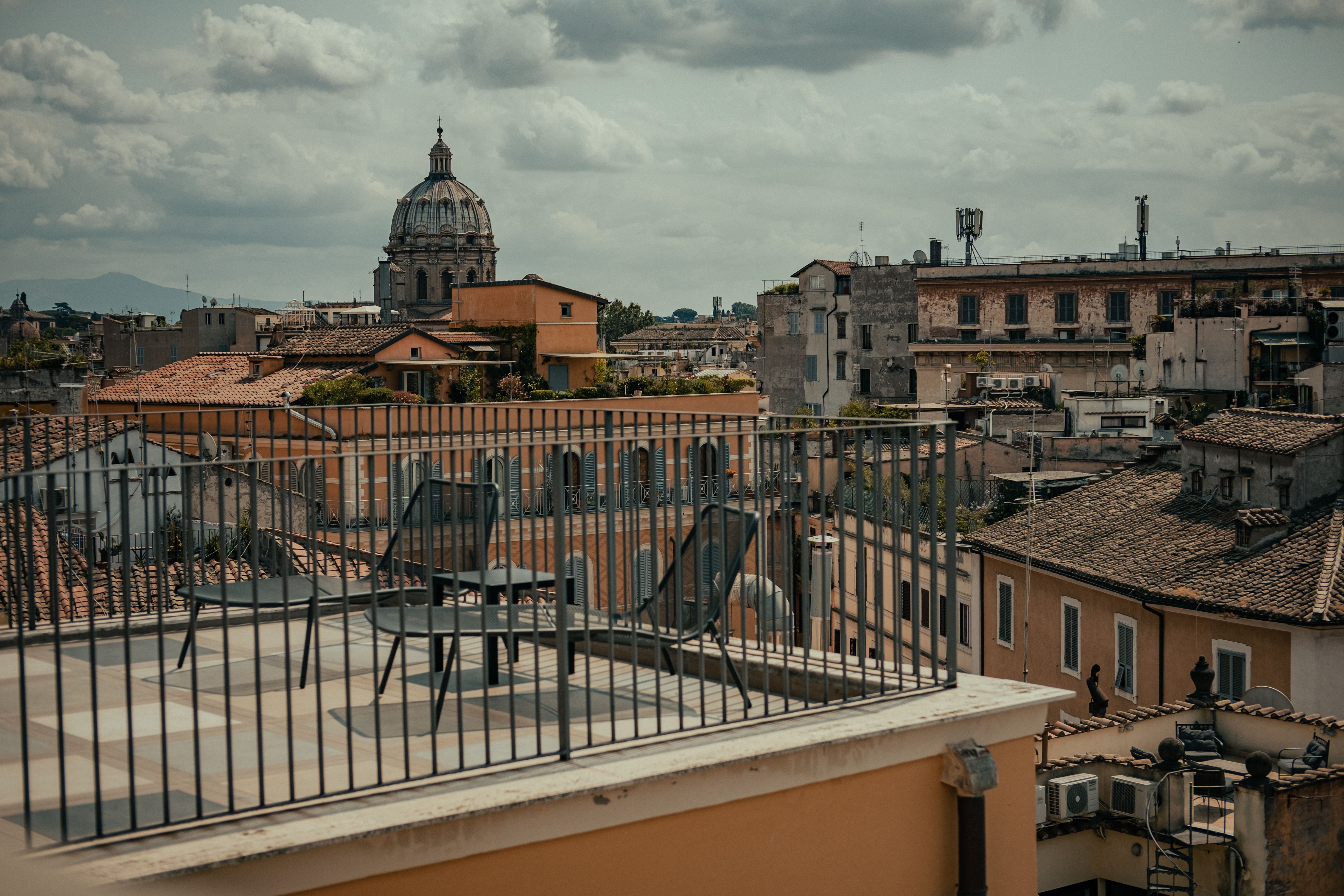 Rooftop terrace overlooking a historic European city, a relaxed spot to unwind during a weekend escape.